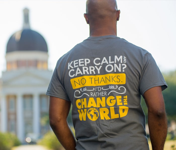 student wearing a change the world t-shirt