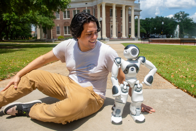 USM's Robot ADA and Student Enoc Lopez