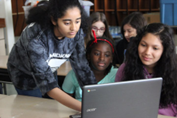 Photo of 3 female students coding representing the Aspirtions in Computing program