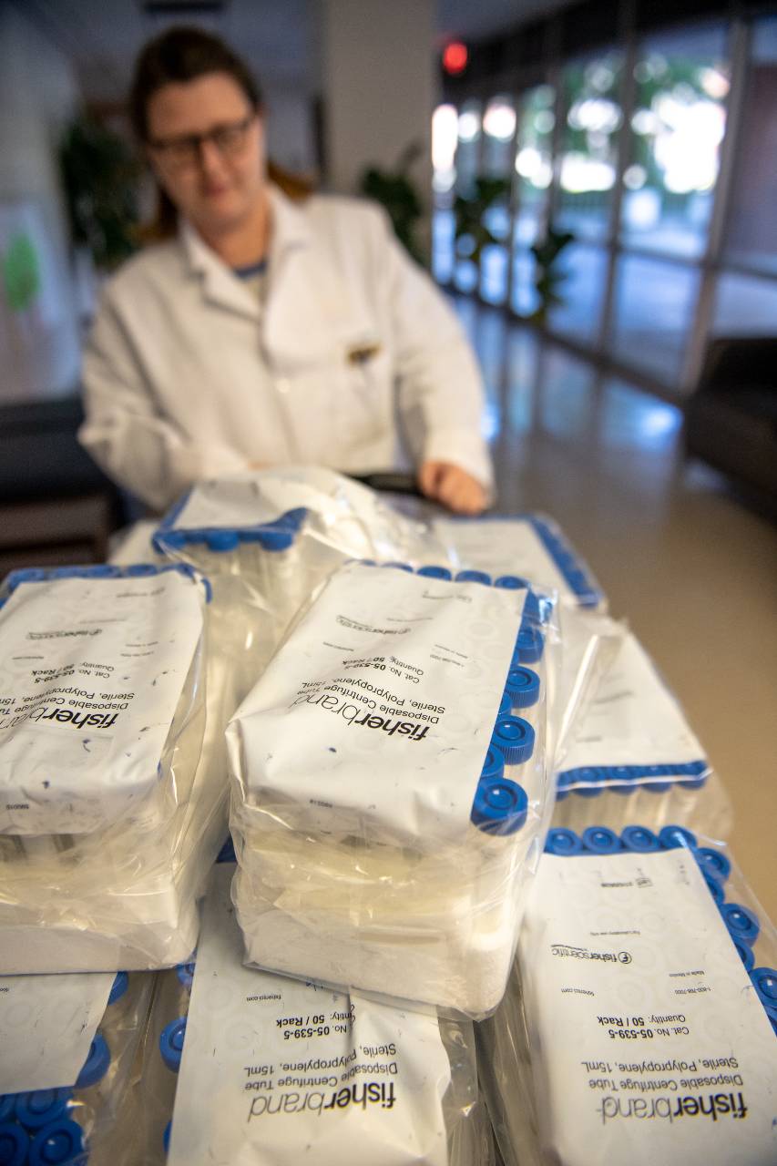 Testing tubes being transported by researcher