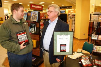 University of Southern Mississippi professor of German Dr. William Odom, right, talks to Christopher Speagle, a junior from Ellisville, about Odom's translation of Hellmut Haasis' biography of Georg Elser, Bombing Hitler, Thursday at the Barnes and Noble bookstore on the Hattiesburg campus. (University Communications photo by David Tisdale)