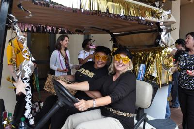 Dr. Cyndi Gaudet, left, and Dr. Heather Annulis have fun driving in The University of Southern Mississippi Gulf Coast's second annual Golf Cart Spirit Parade, celebrating the university's homecoming and Spirit Week.