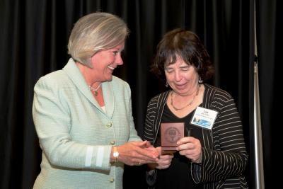 Southern Miss President Martha Saunders presents Jane Yolen with the Southern Miss Medallion at the 45th annual Fay B. Kaigler Children's Book Festival (photo by Kelly Dunn)