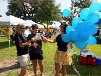 Wren Nightengale distributing You Make Me Smile Balloons prior to the Southern Miss-Southeastern Louisiana football game