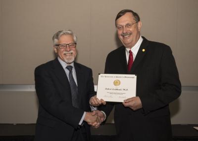 Dr. Robert Lochhead, a former director of The University of Southern Mississippi's School of Polymers and High Performance, was presented the Lifetime Achievement Award May 1 by Provost Denis Wiesenburg at the Faculty Awards Reception and Ceremony. (Photo by Danny Rawls)