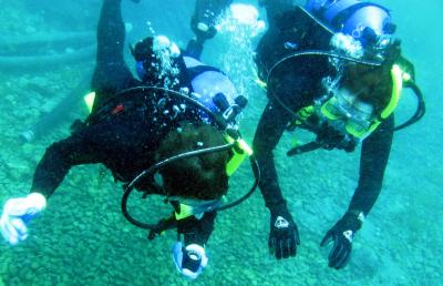 Students enrolled in a Southern Miss scuba certification course practice underwater navigation during an open water dive and skill review. 