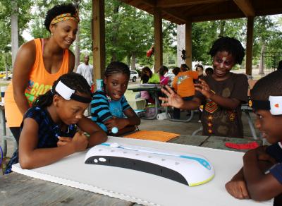 Ha'gar Simpson, top left, a University of Southern Mississippi senior interdisciplinary studies major from State Line, Miss. volunteers at a summer camp for local youth at Hattiesburg Zoo Saturday, June 9.