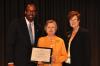 Dr. Sandra Bishop, center, receives the Oustalet Service Award.