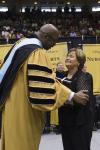 Dr. Rodney D. Bennett presents the posthumous doctorate to Betty Moak.