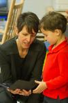 Dr. Julie Cwikla checks out the tablet app with a Pre-K student.