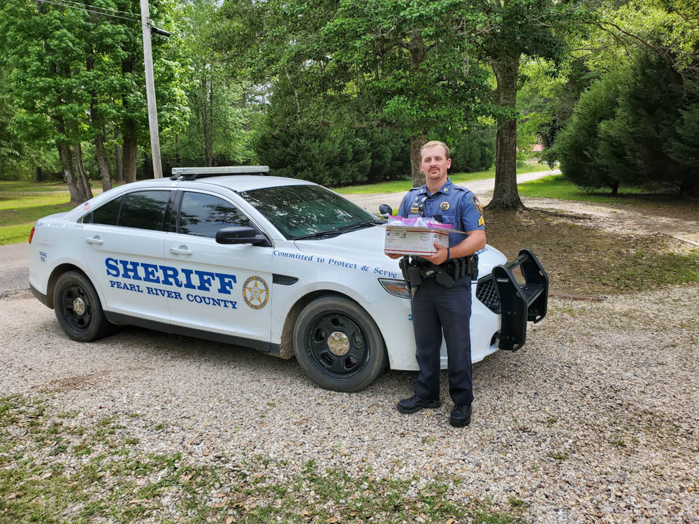 Pearl River County Sheriff Department’s Sgt. Tyler Tate picks up masks made by USM Costume Shop Supervisor Kelly James-Penot and her graduate assistants Mackenzie Dunn and Erin Jester.