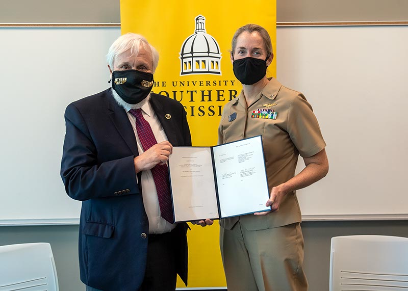 Dr. Gordon Cannon and Rear Adm. Nancy Hann with the agreement