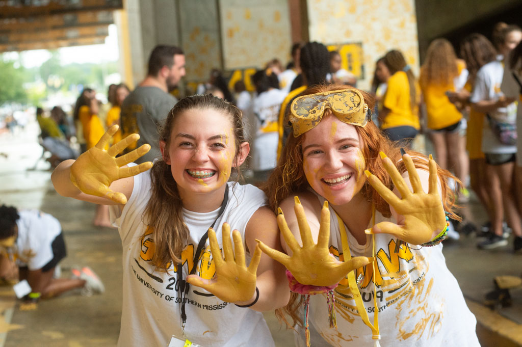 Two students painting the eagle walk