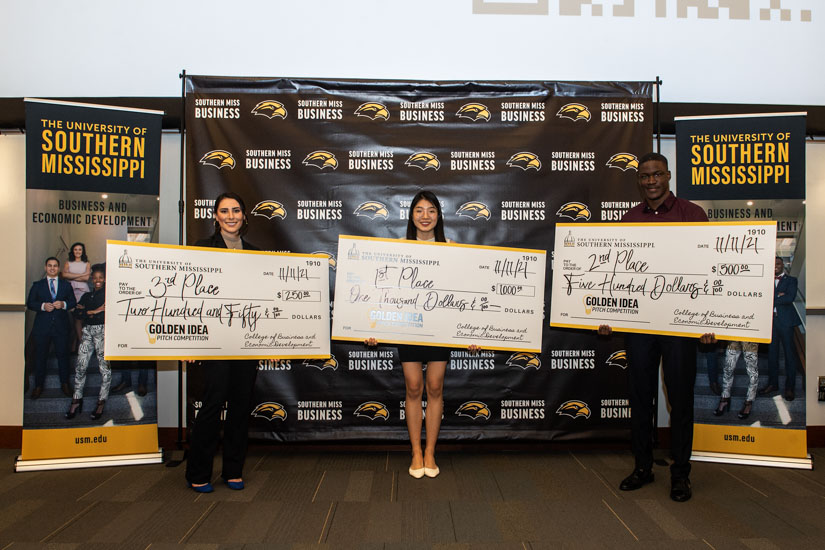 Students holding their winning checks