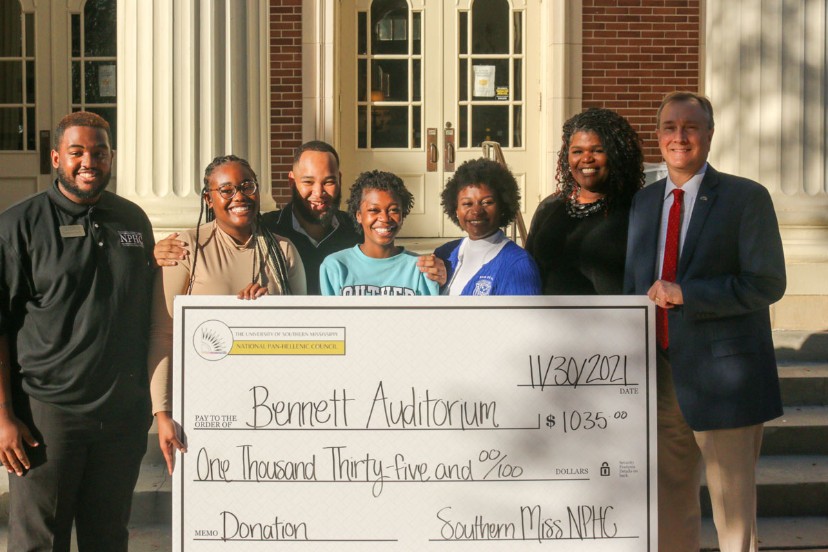 Students holding donation check