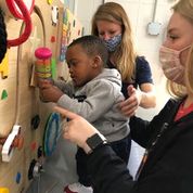 Children with teachers in the sensory room