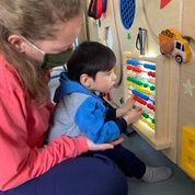 Children with teachers in the sensory room