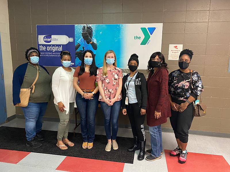 USM MSW students (second from the left) Samantha Brown, Angela Mata and Karla Danner with the mothers of Pine Burr Area Council Boy Scouts who donated multiple care packages to the Waking Joy Project