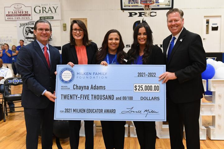 Chayna Adams with the check Photo credit: Milken Educator Awards