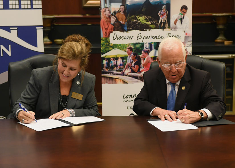 Copiah-Lincoln Community College President Dr. Jane Hulon Sims, left, and University of Southern Mississippi President Dr. Joe Paul sign the MOU. (Photo by Kelly Dunn, USM Photo Services)