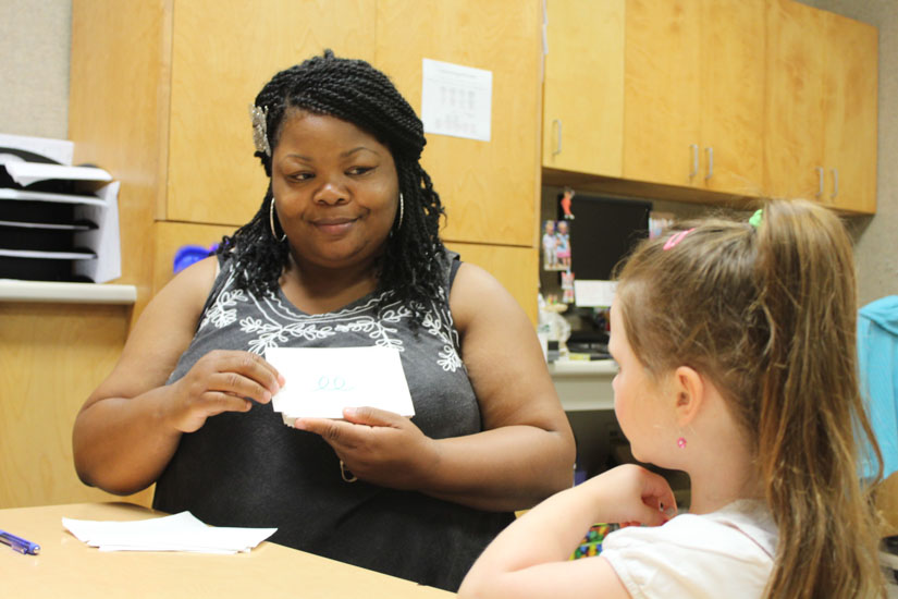 Teacher works with student