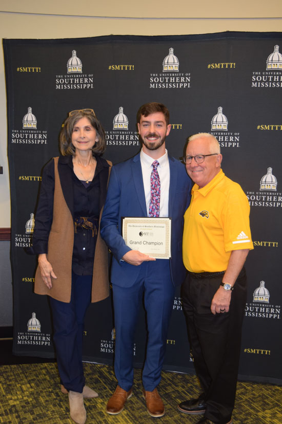 Pictured left to right: Dr. Karen Coats, Dean of USM’s Graduate School, Grand Champion Evan Stacy, and University President Joe Paul.