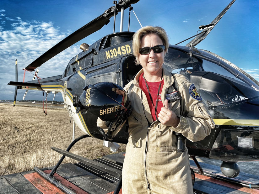 Dr. Stephanie Parks standing beside helicopter