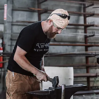 Man hammering an anvil 