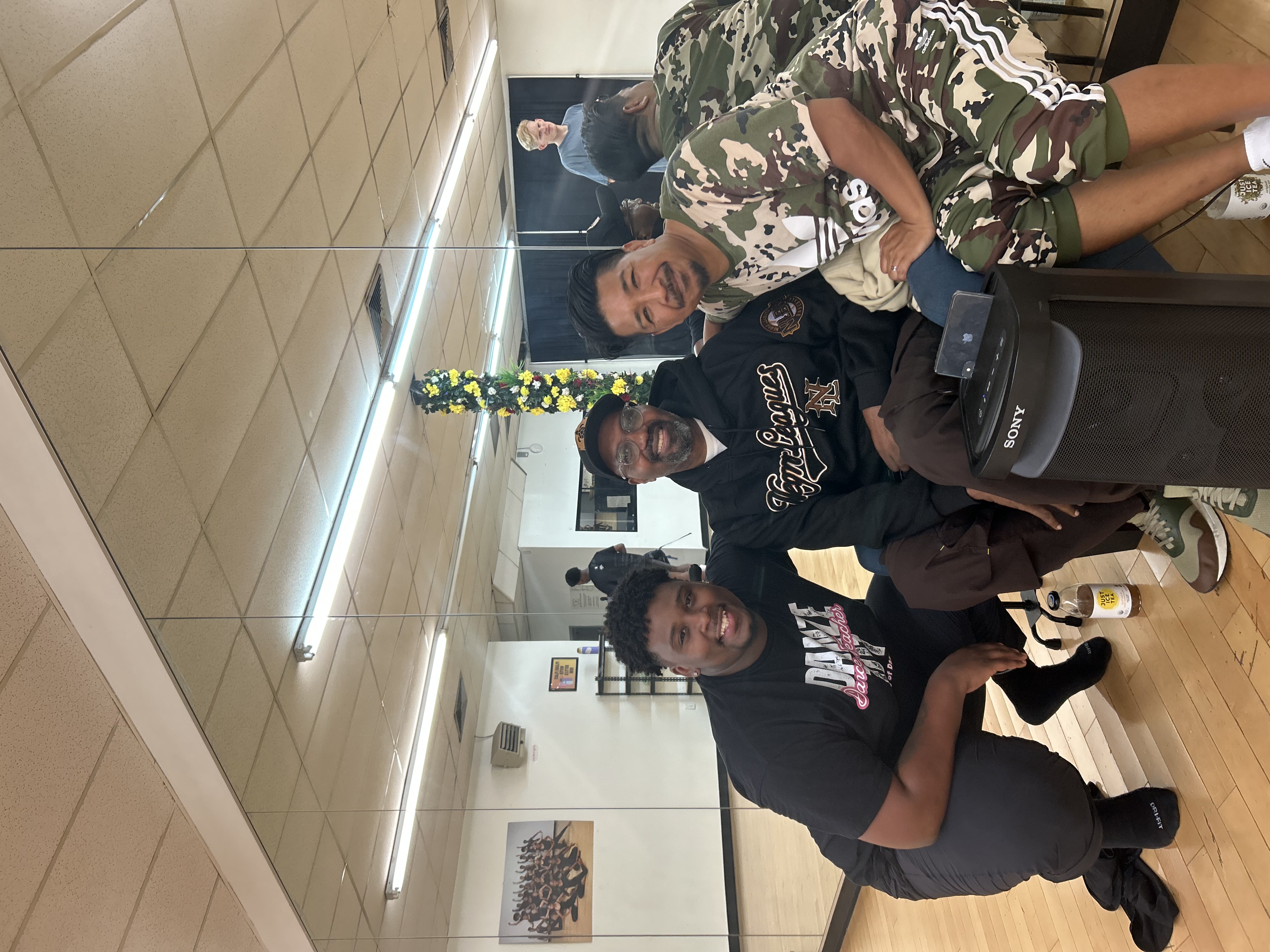 Derreck Williams, Ronald K. Brown, and Arcell Caubag three men squatting an posing for a photo