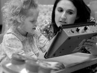 instructor assisting student with listening device