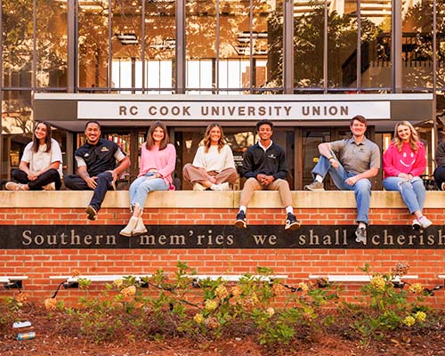 students sitting outside the hub